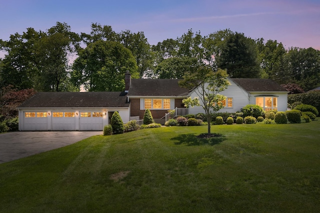 18 Halsey Pl, Valhalla, NY 10595 - view of front of house with concrete driveway, a chimney, a front lawn, a garage, and view of wooded area