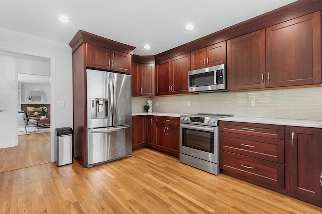 18 Halsey Pl, Valhalla, NY 10595 - kitchen with appliances with stainless steel finishes, light countertops, light wood-type flooring, tasteful backsplash, and recessed lighting