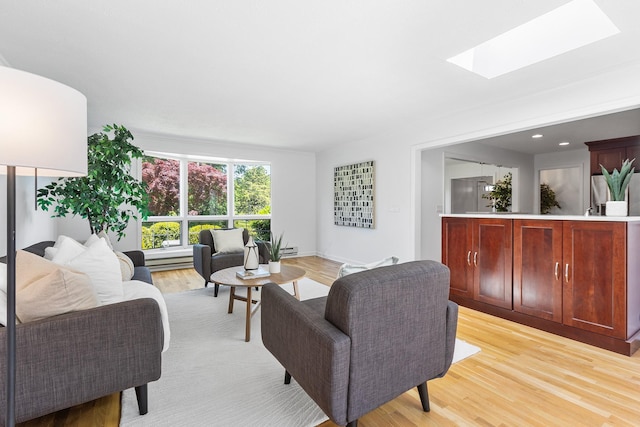 18 Halsey Pl, Valhalla, NY 10595 - living room featuring a skylight, light wood finished floors, and baseboard heating