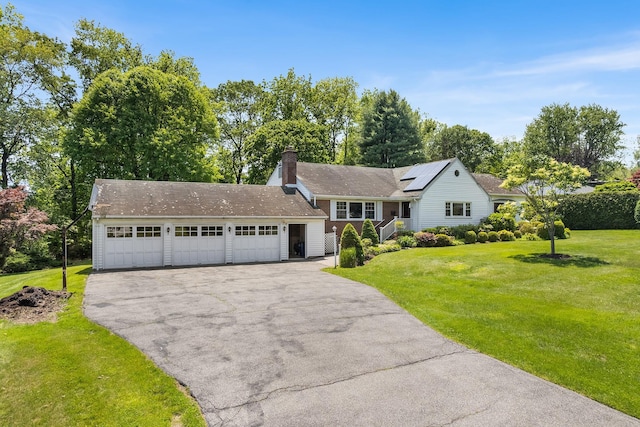 18 Halsey Pl, Valhalla, NY 10595 - split level home with a chimney, a front yard, roof mounted solar panels, and a garage