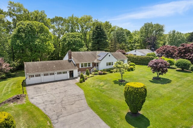 18 Halsey Pl, Valhalla, NY 10595 - view of front of house featuring asphalt driveway, a front yard, a garage, and a chimney