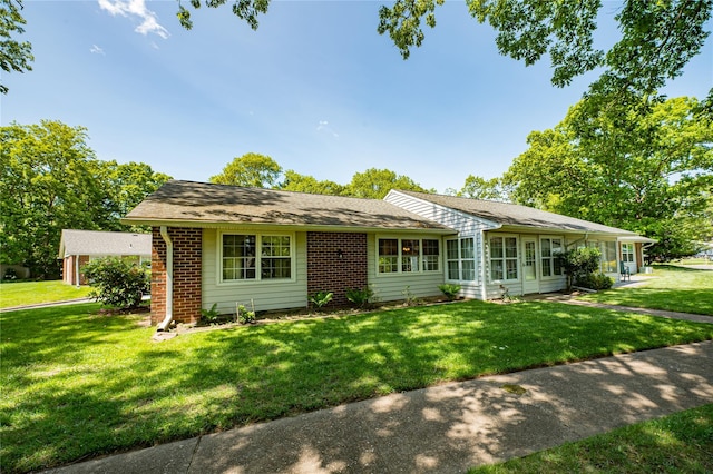 119 Exmore Ct Unit A, Ridge, NY 11961 - single story home with a front lawn and brick siding