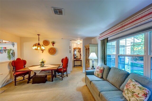119 Exmore Ct Unit A, Ridge, NY 11961 - living room featuring a chandelier and light colored carpet