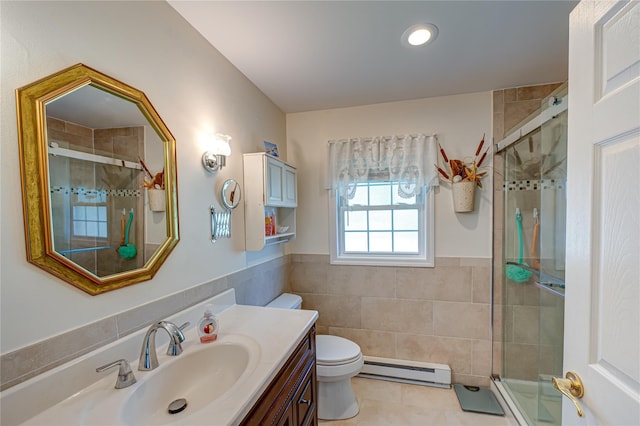 119 Exmore Ct Unit A, Ridge, NY 11961 - bathroom featuring baseboard heating, vanity, toilet, tile walls, and a shower stall
