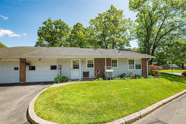 119 Exmore Ct Unit A, Ridge, NY 11961 - view of front of property with a garage, a front lawn, driveway, and brick siding