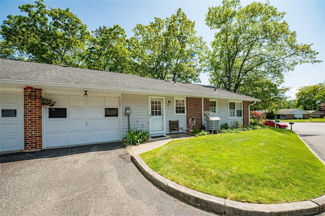 119 Exmore Ct Unit A, Ridge, NY 11961 - single story home with an attached garage, a front yard, and asphalt driveway