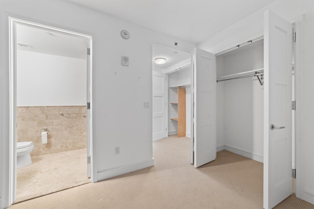 5 Renaissance Sq Unit 10G, White Plains, NY 10601 - unfurnished bedroom featuring carpet floors, ensuite bath, and a closet