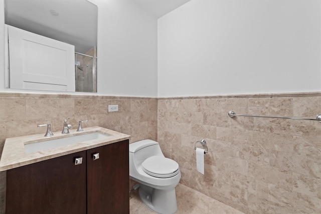 5 Renaissance Sq Unit 10G, White Plains, NY 10601 - bathroom featuring a shower, vanity, toilet, wainscoting, and tile walls