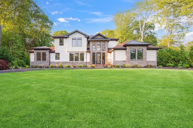 21 Arista Dr, Dix Hills, NY 11746 - view of front facade with stone siding, a standing seam roof, and a front lawn