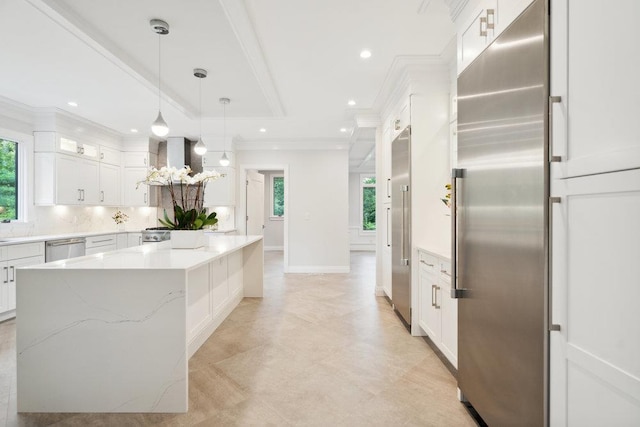 21 Arista Dr, Dix Hills, NY 11746 - kitchen featuring wall chimney range hood, crown molding, a large island, white cabinetry, and stainless steel appliances