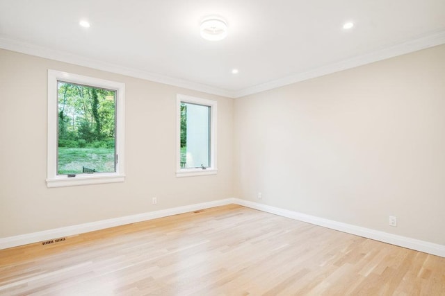 21 Arista Dr, Dix Hills, NY 11746 - spare room featuring healthy amount of natural light, light wood-type flooring, ornamental molding, and recessed lighting