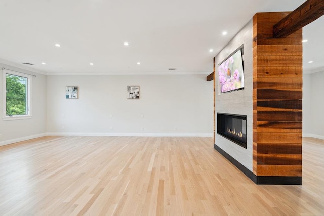 21 Arista Dr, Dix Hills, NY 11746 - unfurnished living room featuring crown molding, light wood-style flooring, a fireplace, and recessed lighting