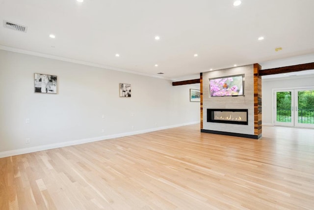 21 Arista Dr, Dix Hills, NY 11746 - unfurnished living room with ornamental molding, recessed lighting, a fireplace, and light wood-type flooring