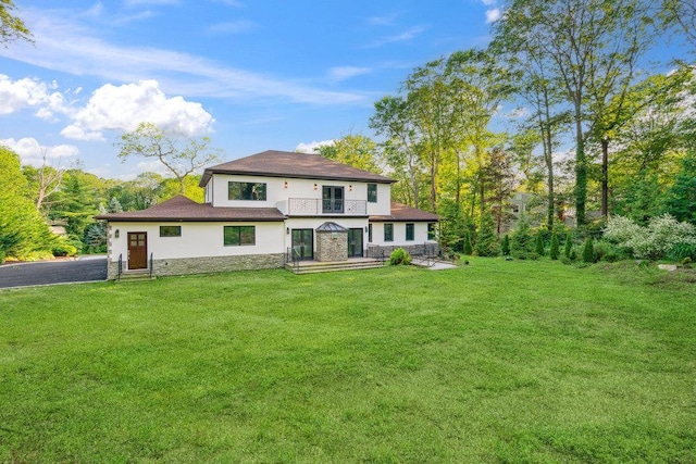 21 Arista Dr, Dix Hills, NY 11746 - rear view of property featuring stone siding, stucco siding, a lawn, and a balcony
