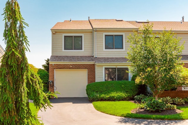10 Hidden Harbor Dr Unit 10, Babylon, NY 11702 - view of front of home featuring an attached garage, concrete driveway, a shingled roof, and brick siding