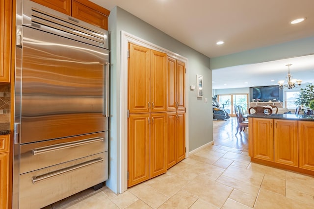 10 Hidden Harbor Dr Unit 10, Babylon, NY 11702 - kitchen with stainless steel built in fridge, recessed lighting, a chandelier, decorative backsplash, and brown cabinets