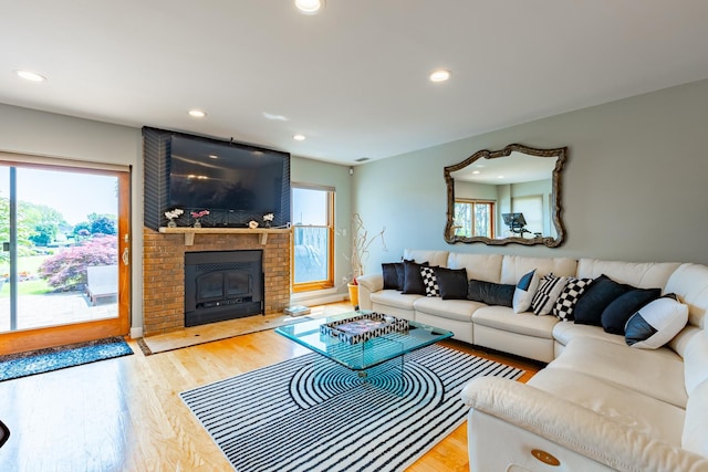 10 Hidden Harbor Dr Unit 10, Babylon, NY 11702 - living room featuring healthy amount of natural light, recessed lighting, wood finished floors, and a fireplace