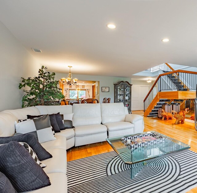 10 Hidden Harbor Dr Unit 10, Babylon, NY 11702 - living area with stairway, a chandelier, wood finished floors, and recessed lighting
