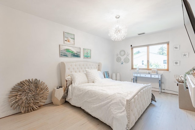 10 Hidden Harbor Dr Unit 10, Babylon, NY 11702 - bedroom featuring light wood-style floors and a chandelier