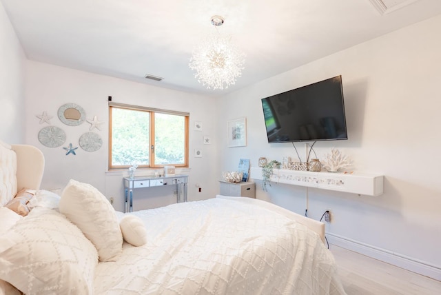 10 Hidden Harbor Dr Unit 10, Babylon, NY 11702 - bedroom featuring wood finished floors, a chandelier, and baseboards