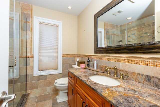 10 Hidden Harbor Dr Unit 10, Babylon, NY 11702 - full bathroom featuring tile walls, vanity, a shower stall, toilet, and tile patterned floors