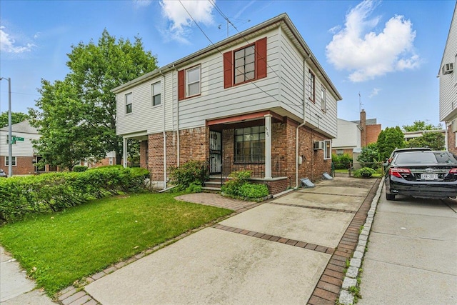 47-03 212th St, Bayside, NY 11361 - view of front of home with a front yard, brick siding, and concrete driveway