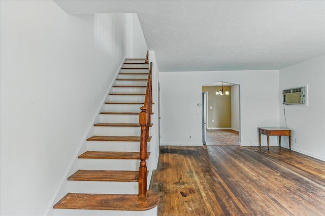 47-03 212th St, Bayside, NY 11361 - stairs with a wall unit AC, hardwood / wood-style floors, a chandelier, and arched walkways