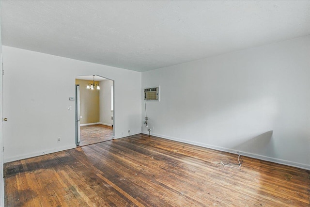 47-03 212th St, Bayside, NY 11361 - unfurnished room with a chandelier, wood-type flooring, and a wall mounted AC