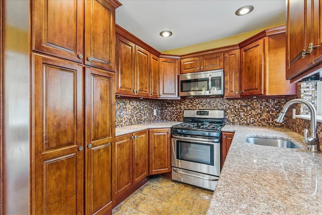 47-03 212th St, Bayside, NY 11361 - kitchen featuring stainless steel appliances, decorative backsplash, light stone countertops, and brown cabinetry