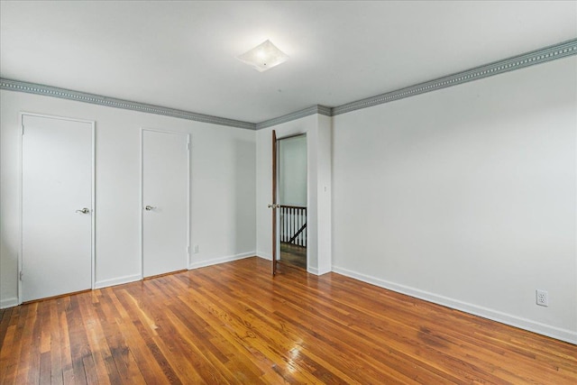 47-03 212th St, Bayside, NY 11361 - unfurnished bedroom with wood-type flooring and crown molding