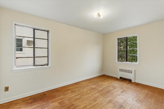 47-03 212th St, Bayside, NY 11361 - empty room featuring radiator heating unit and light wood-style floors