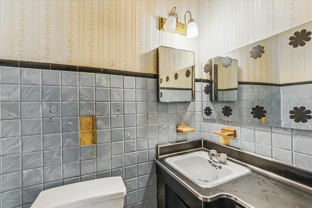 47-03 212th St, Bayside, NY 11361 - half bath with wallpapered walls, tile walls, vanity, and a wainscoted wall