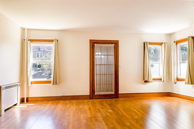 5428 65th Pl, Maspeth, NY 11378 - spare room featuring radiator heating unit, wood finished floors, and baseboards