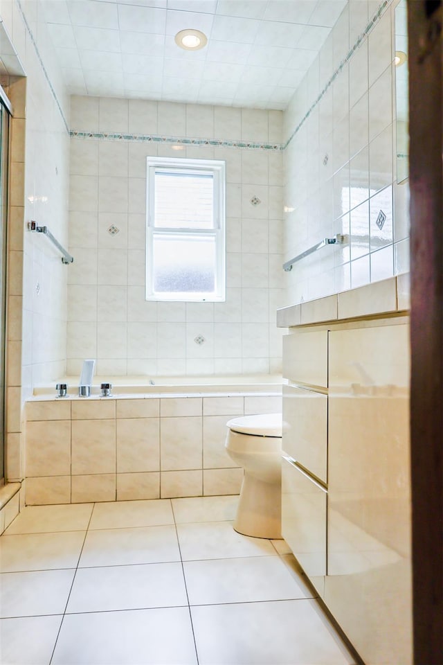 5428 65th Pl, Maspeth, NY 11378 - bathroom with tile patterned floors, toilet, a tile shower, tile walls, and tiled tub