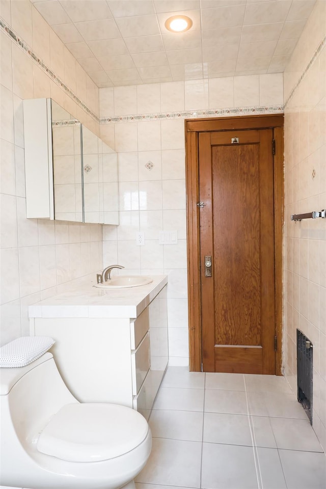 5428 65th Pl, Maspeth, NY 11378 - half bath with tile walls, vanity, tile patterned floors, and toilet