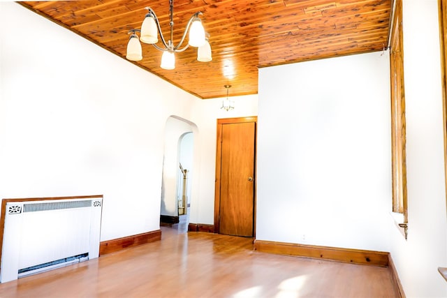 5428 65th Pl, Maspeth, NY 11378 - unfurnished room with radiator heating unit, wooden ceiling, arched walkways, a chandelier, and baseboards
