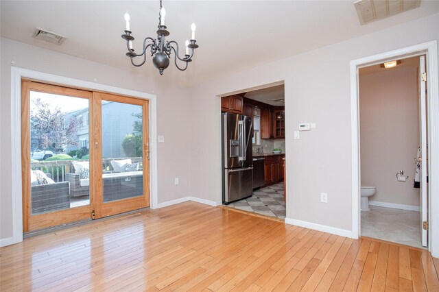 48 Zugibe Ct, West Haverstraw, NY 10993 - spare room featuring a chandelier, light wood-style floors, baseboards, and a sink