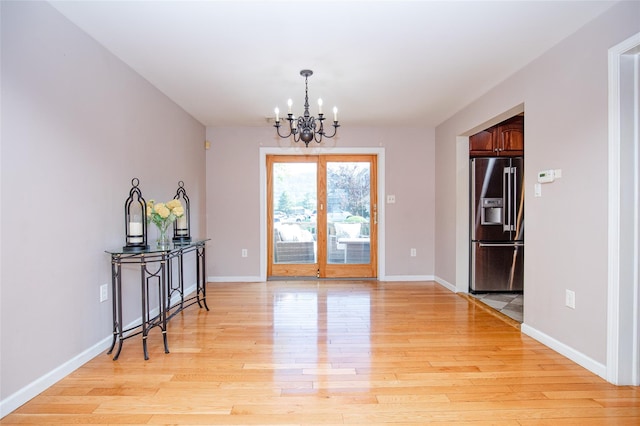 48 Zugibe Ct, West Haverstraw, NY 10993 - dining room featuring a chandelier, light wood-style floors, and baseboards