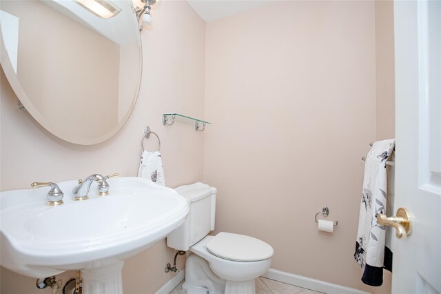 48 Zugibe Ct, West Haverstraw, NY 10993 - bathroom featuring toilet, tile patterned flooring, baseboards, and a sink