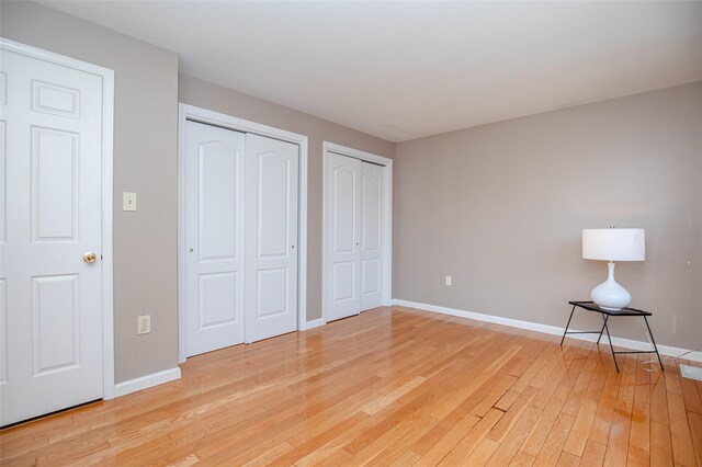 48 Zugibe Ct, West Haverstraw, NY 10993 - unfurnished bedroom featuring two closets, light wood-style flooring, and baseboards