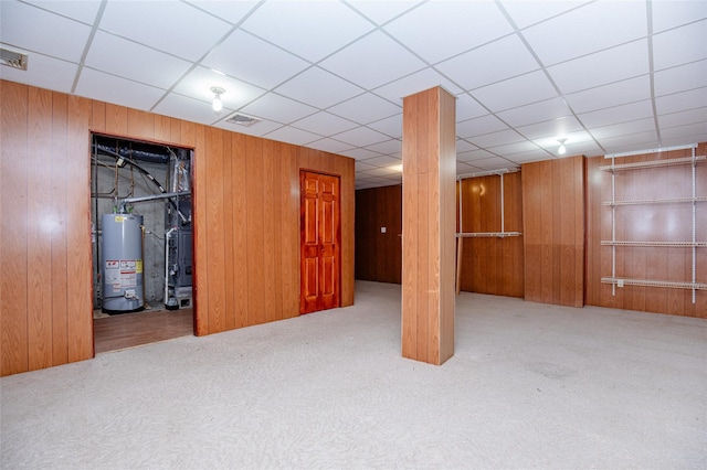 48 Zugibe Ct, West Haverstraw, NY 10993 - finished below grade area with gas water heater, carpet, wood walls, heating unit, and a paneled ceiling