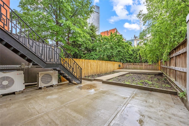 2118 45th Ave Unit 1And 2, Long Island City, NY 11101 - fenced backyard featuring a cooling unit, stairway, a patio, and a vegetable garden