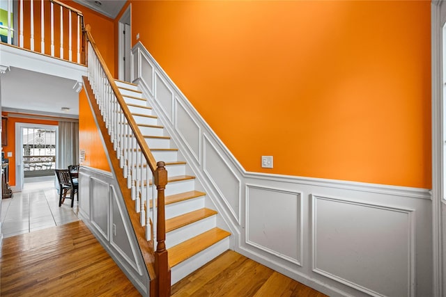 924 Otsego Ct, West Hempstead, NY 11552 - staircase with a decorative wall, wainscoting, and wood finished floors