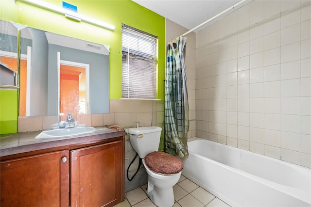 924 Otsego Ct, West Hempstead, NY 11552 - bathroom with toilet, tile patterned flooring, vanity, shower / bath combo with shower curtain, and tile walls
