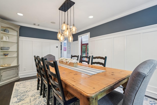 1 Highwoods Rd, Saint James, NY 11780 - dining room featuring a decorative wall, crown molding, dark wood finished floors, a chandelier, and wainscoting