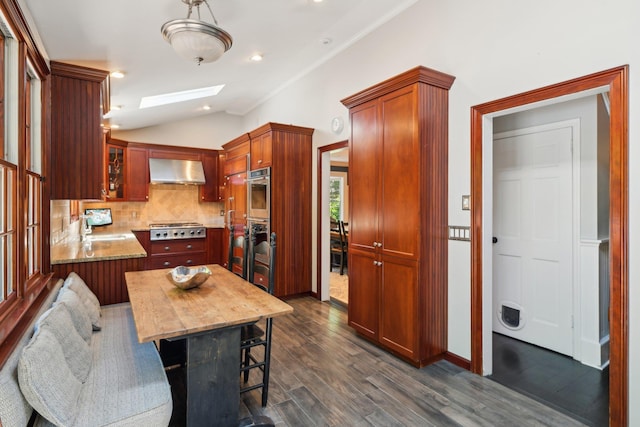 1 Highwoods Rd, Saint James, NY 11780 - kitchen with exhaust hood, a skylight, stainless steel gas cooktop, backsplash, and dark wood finished floors