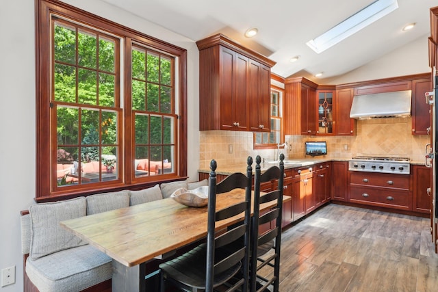 1 Highwoods Rd, Saint James, NY 11780 - kitchen with wall chimney exhaust hood, stainless steel gas stovetop, lofted ceiling, light stone countertops, and a skylight