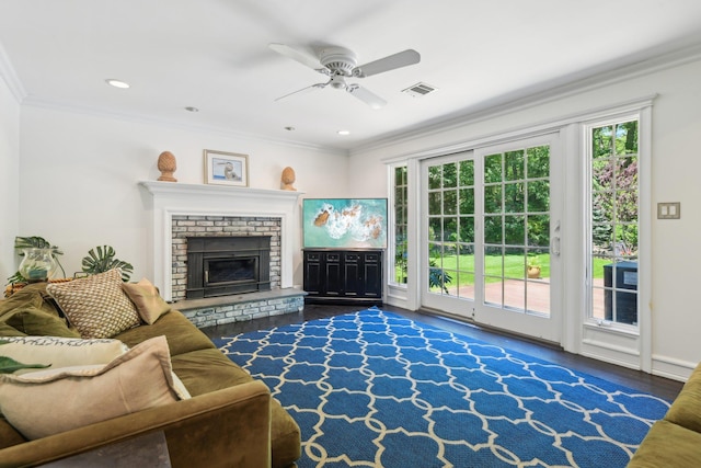 1 Highwoods Rd, Saint James, NY 11780 - living room with crown molding, healthy amount of natural light, a ceiling fan, wood finished floors, and a brick fireplace