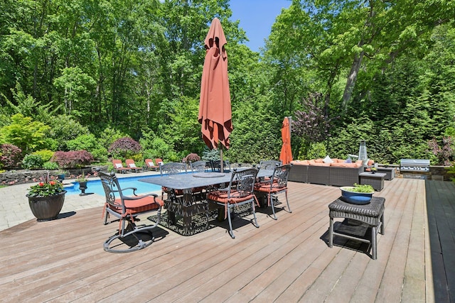 1 Highwoods Rd, Saint James, NY 11780 - wooden deck featuring grilling area, outdoor dining space, an outdoor pool, outdoor lounge area, and a wooded view