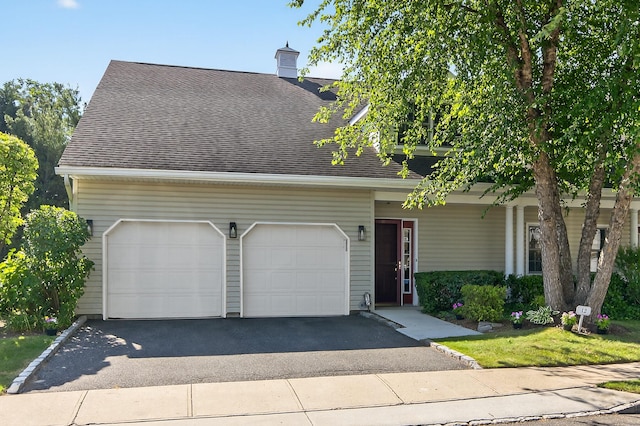 12 Miro Pl Unit 31, Port Washington, NY 11050 - view of front of property with asphalt driveway, a shingled roof, an attached garage, and a chimney
